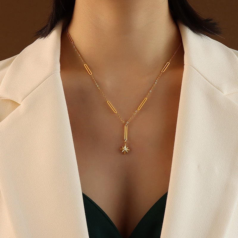 Gold-tone star pendant necklace with geometric chain on model – minimalist stainless steel jewelry by JSC Jewelry.