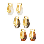 Gold U-shaped resin ear cuffs with white, black, and amber accents – modern stainless steel jewelry by JSC Jewelry.