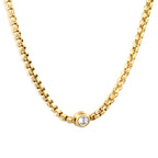 Elegant white diamond pendant necklace on a stainless steel and gold-tone chain — minimalist luxury jewelry by JSC Jewelry.