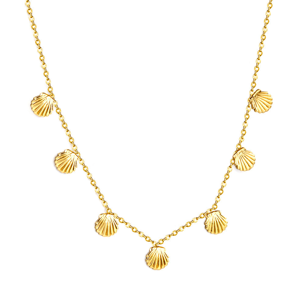 Gold-tone charm necklace set from JCS featuring shell, cherry, crown, and red dragonfly pendants — hypoallergenic and water-resistant.