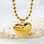 Ketting met holle harthanger en golvende kralenketting
