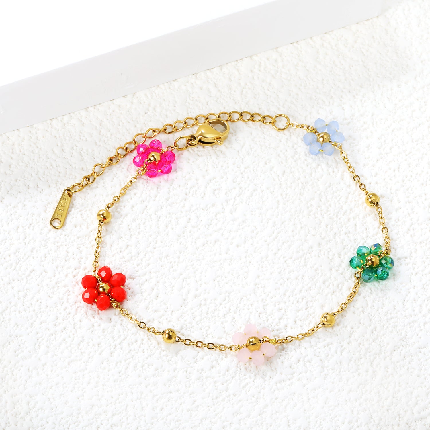 Bracelet en acier et perles de fleurs