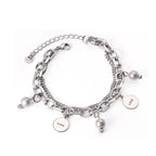 Dikke armband met gouden hartbedel 