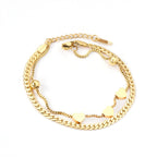 Dikke armband met gouden hartbedel 