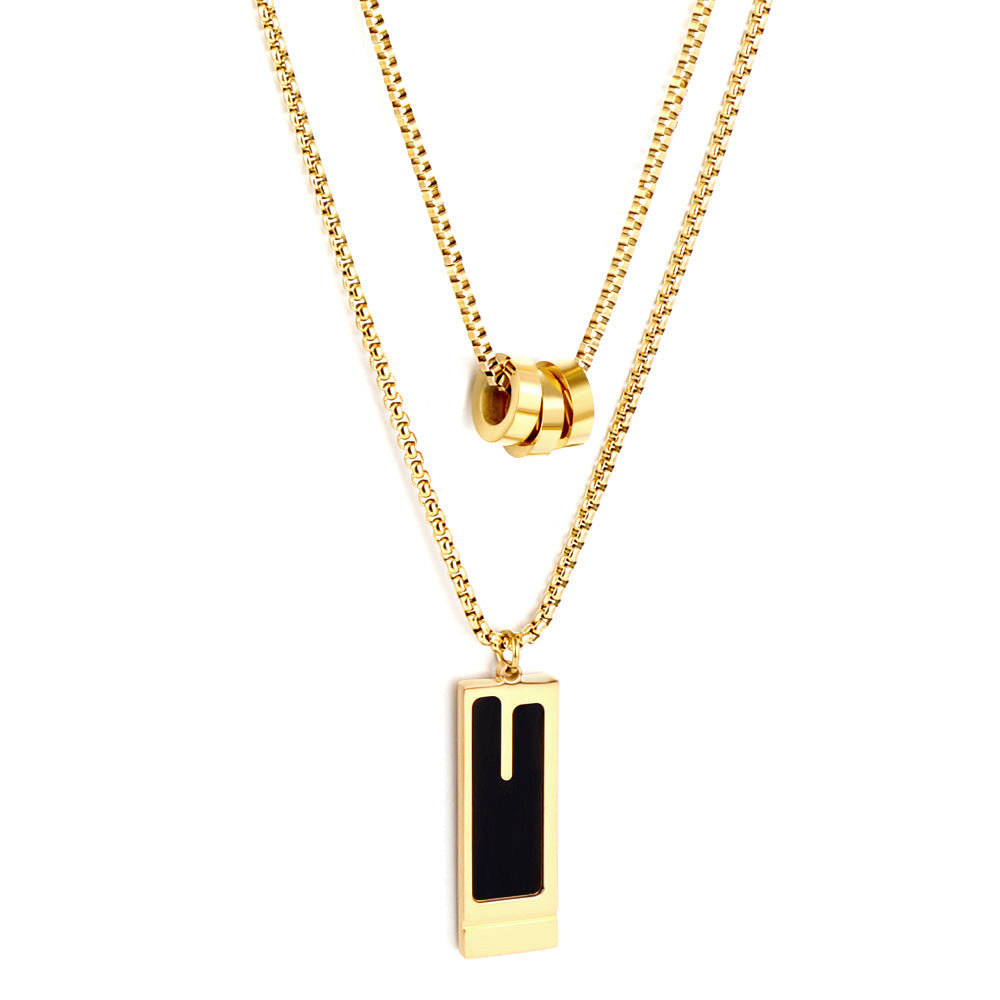 Gold-tone stainless steel double chain necklace featuring three round hollow pendants and a rectangular black enamel drop — by JCS Jewelry.