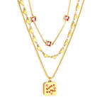 Drievoudige ketting met groen hart en roze zirkonia bedeltjes